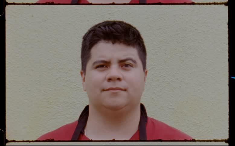 Close up of a mans face as he stares blankly in front of a white wall