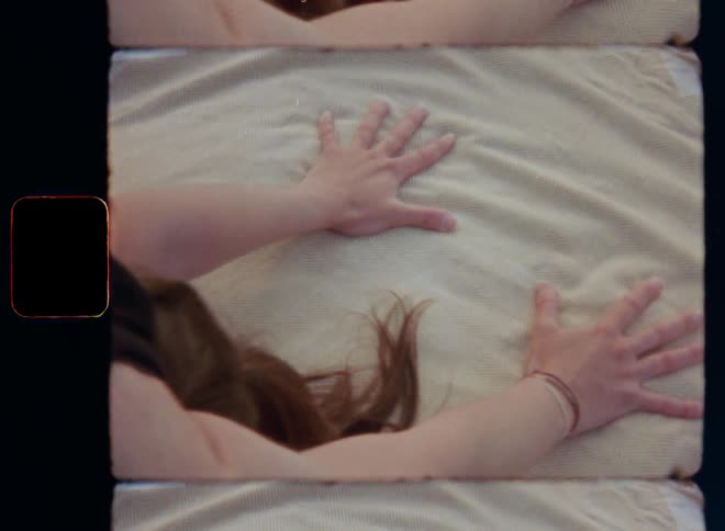 Woman with her hands on soft blanket or towel on the ground doing downward facing dog yoga pose for a relaxing body stretch leaning backward to relief tension and stress practicing mindfulness harmony and mental health awareness