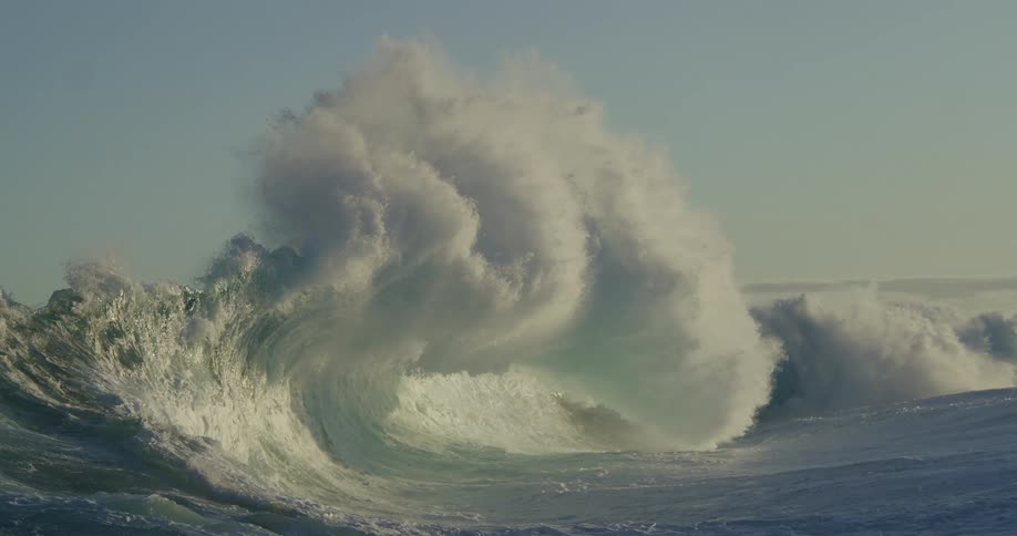 Slow motion of a powerful wave with a lot of foam breaking in the sea