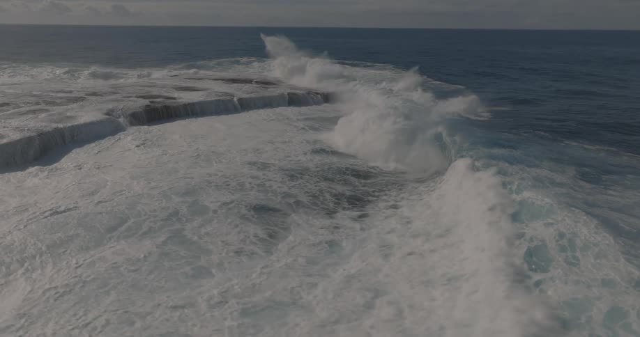 The waves crash on the island
