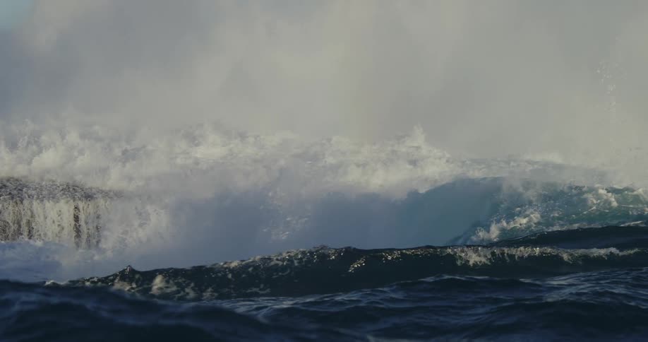 Large waves crash against the shore