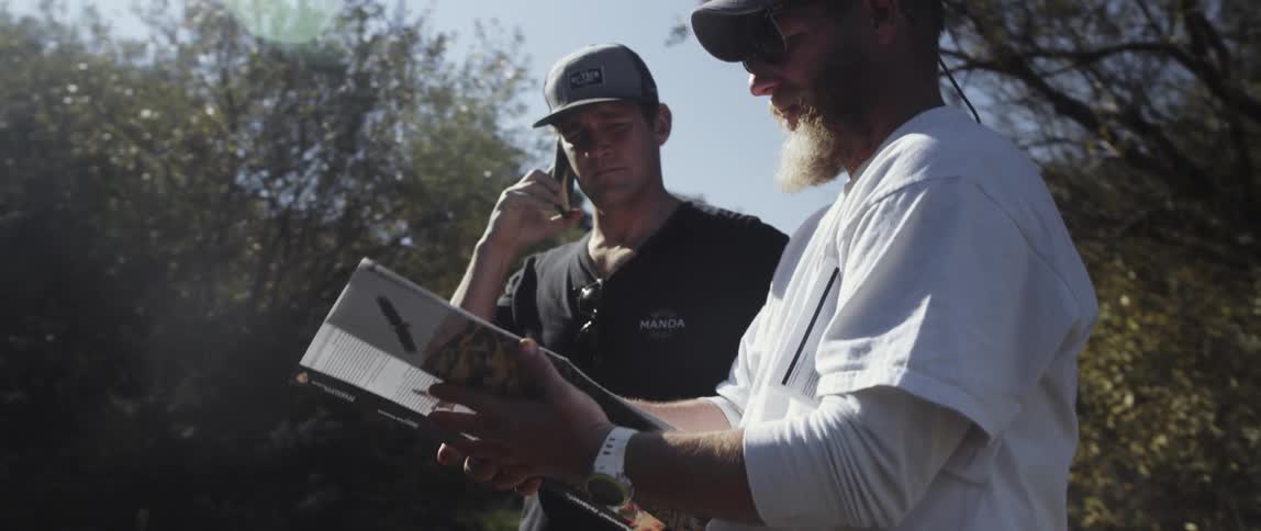 Two men look at a map together