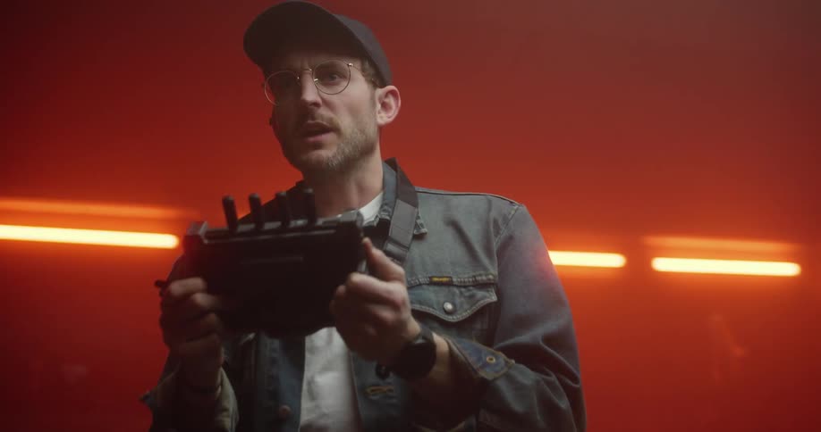 Man wearing a cap speaking something while holding a technological remote control