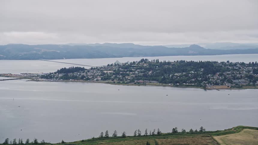 Aerial view of the coastal town of Astoria Oregon nestled beside Youngs Bay showcasing the residential areas by the sea during a sunny summer day