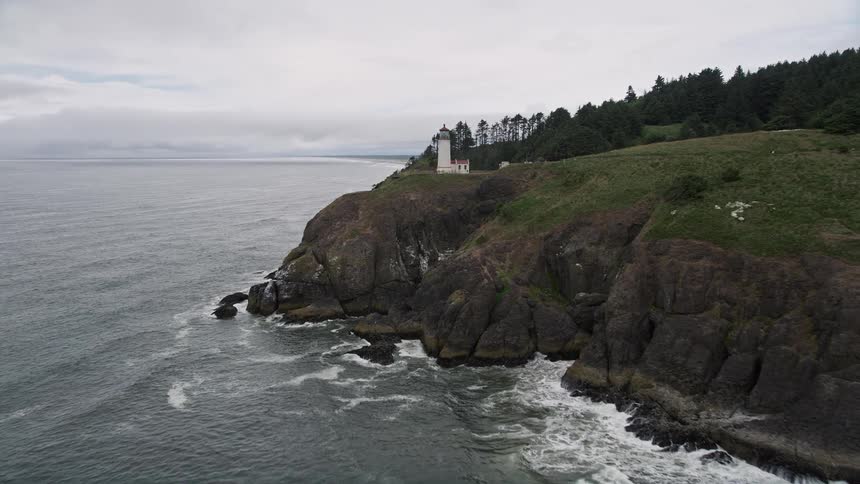 Approaching the North Head Light on a steep coastal cliff in Ilwaco Washington during a sunny day in summer