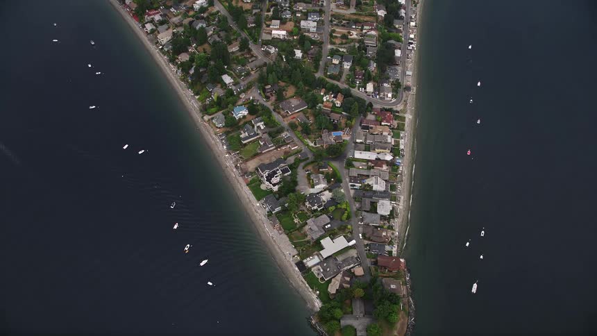 Aerial view of the waterfront community of Burien Washington showcasing residential neighborhoods with lush vegetation by the sea