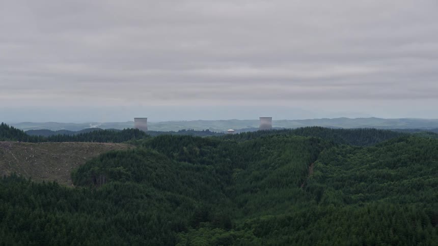 Aerial footage of the Satsop Nuclear Power Plant's cooling towers in Satsop Washington on an overcast day