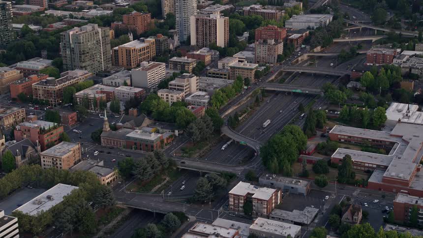 Aerial view of vehicles driving down Interstate 405 in Downtown Portland Oregon during sunset