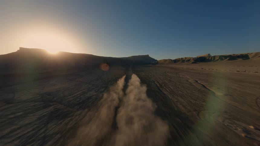 Two people racing motocross in the desert