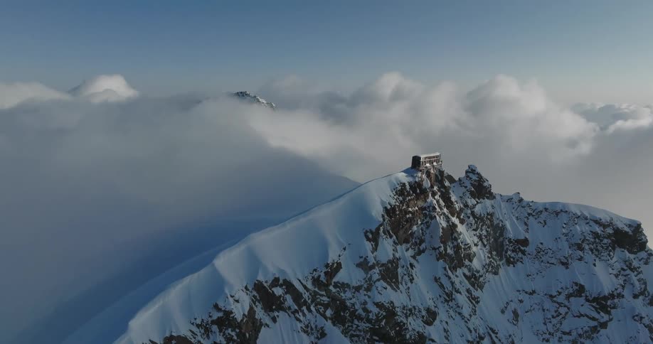 Clouds passing over ice covered mountains