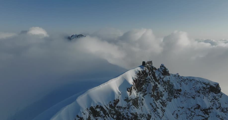 Snowcovered mountains at cloud level