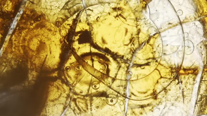 A slow movement of cooking oil with bubbles