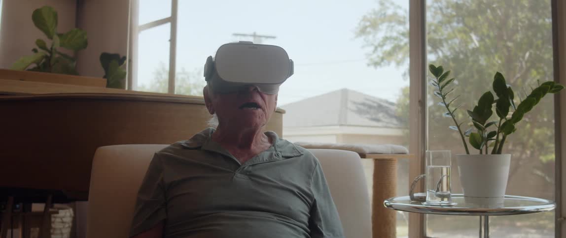 Elderly person using virtual reality glasses and is happy
