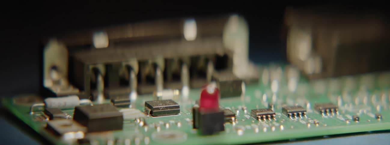 A soldering iron soldering a component on an electronic board