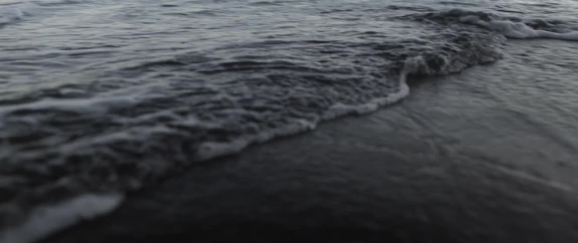 Waves slowly move over the beach