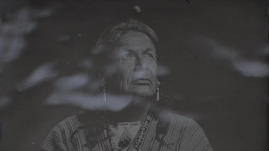 Photograph of a person from an indigenous tribe being developed in black and white with liquid