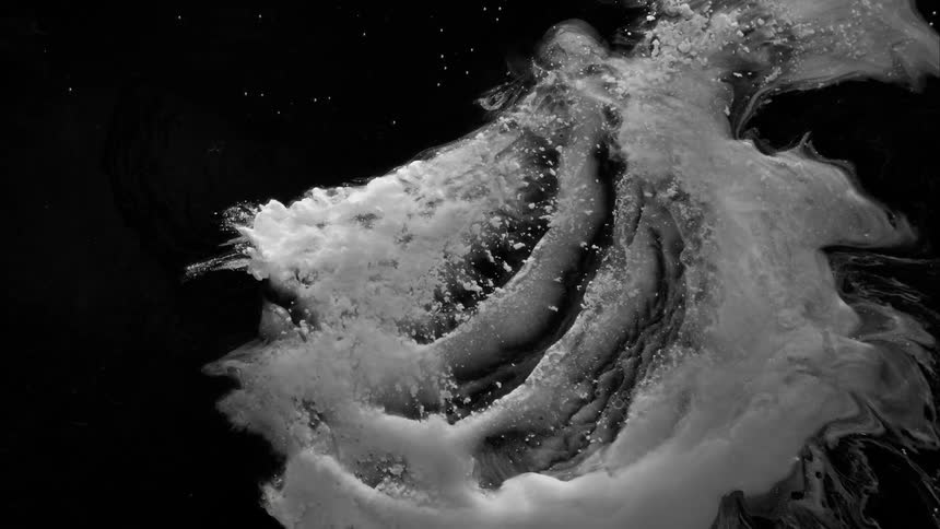 Slow motion footage of a wave moving in an ocean at night