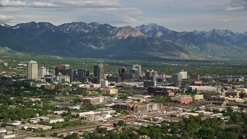 an aerial view of Salt Lake City Utah with majestic mountains and a bustling metropolis in the background