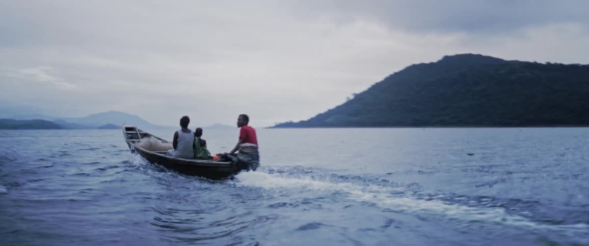 People speed by on a boat in the lake