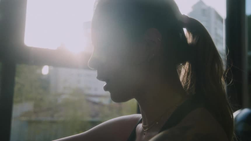 A woman is breathing heavy while exercising
