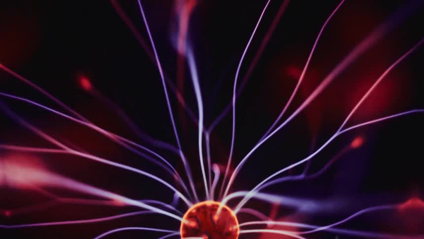 Neon special effect of shockwaves emanating from a sphere on a black and abstract background