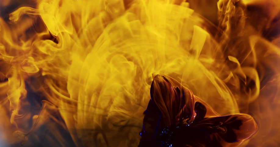 A dark red blob of congealed liquid falls onto flames