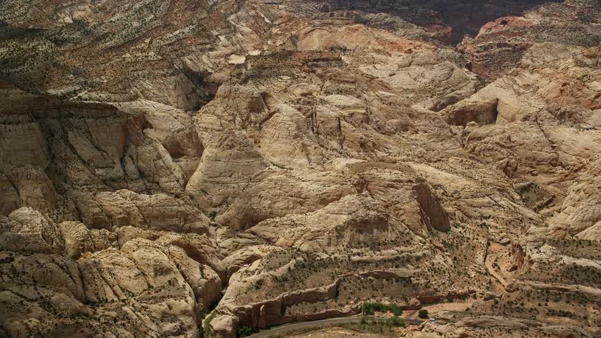 Drone captures breathtaking aerial view of the Waterpocket Fold rock formations in Capitol Reef National Park Utah on a sunny day