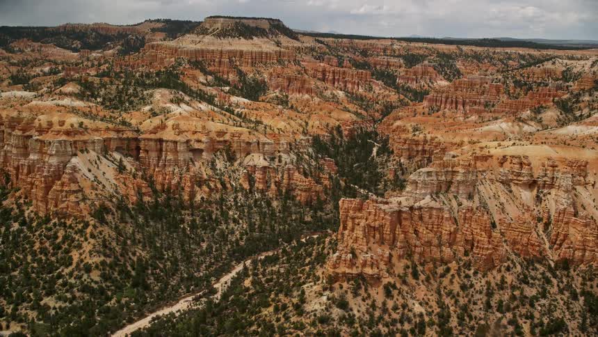Aerial view of hoodoos buttes and mesas in Bryce Canyon National Park Utah with cloudy skies and desert landscape