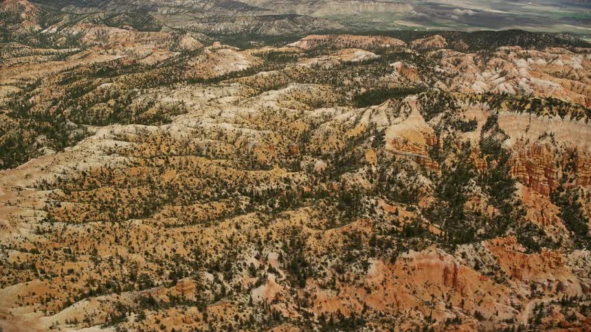 Aerial stock footage of buttes hills and hoodoos at Bryce Canyon National Park Utah captured during a cloudy summer day