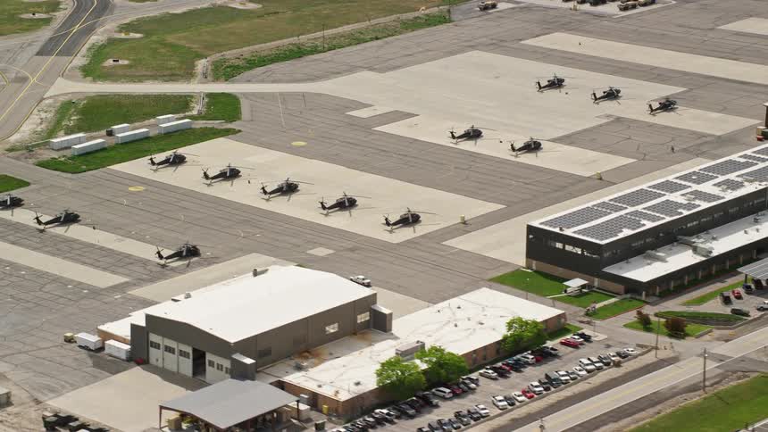  aerial footage of helicopters hangars and buildings at South Valley Regional Airport in Utah filmed during a sunny day in summer