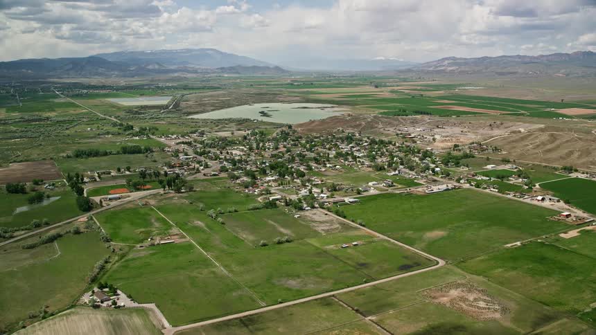 Approaching a rustic rural town with farms and Redmond Lake in Redmond Utah on a partly cloudy day in the Southwest United States