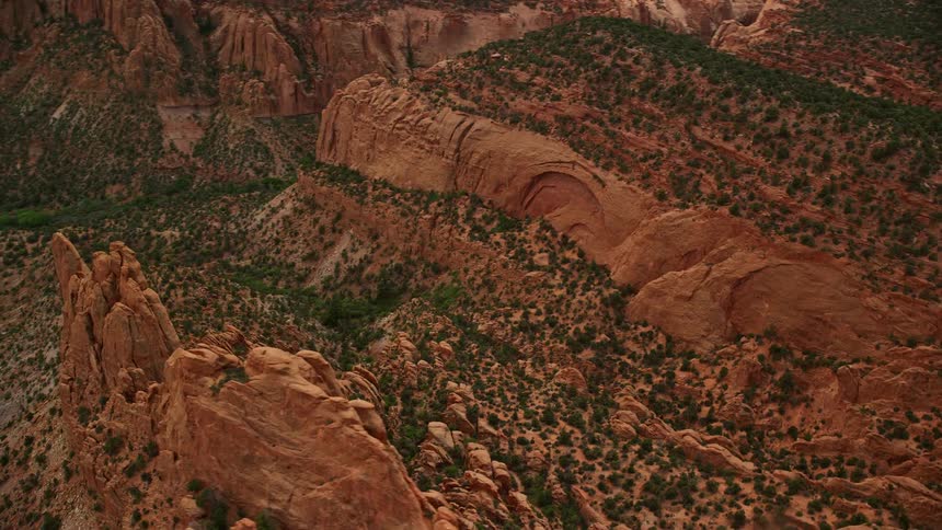 Flying over Capitol Reef National Park in Utah during summer thisaerial footage captures the mesmerizing sight of mesas and a butte surrounded by arid desert landscapes