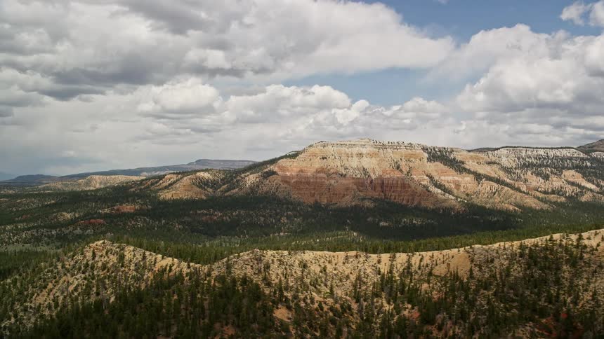  aerial footage of Barney Top Mesa in Utah featuring a wide view of the mesa with desert vegetation in the foreground showcasing the stunning Southwest desert landscape during summer