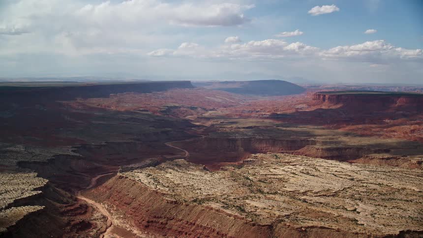 Aerial footage of flying over wide desert canyon in Navajo Nation Reservation Arizona and Utah showcasing the landscape and natural beauty of the Southwest United States during midday