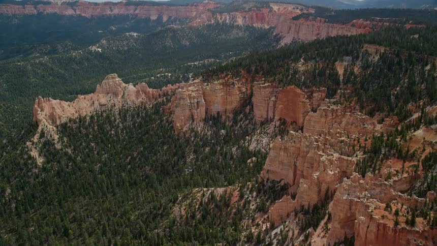 Breathtakingaerial footage of flying over and approaching the stunning buttes forest and Bryce Canyon National Park in Utah during a beautiful summer day