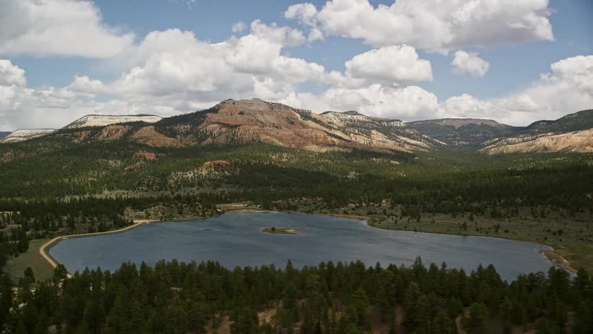 Stunning aerial view of Pine Lake and Barney Top Mesa in Utah's desert landscape captured on a cloudy day showcasing the mesmerizing beauty of the Southwest United States