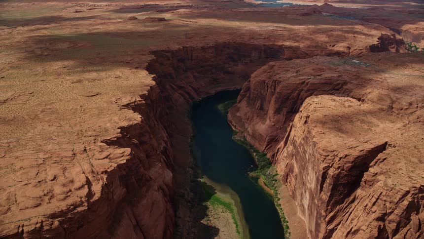 Aerial footage of the Colorado River and steep cliffs in Glen Canyon Arizona captured inresolution during a sunny day in the Southwest United States