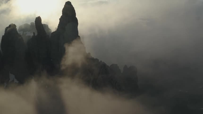 Cliffs with fog and ice with the sky and clouds in the background