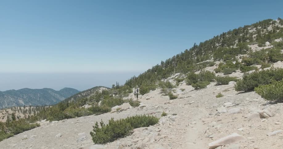 A man walks down the hill