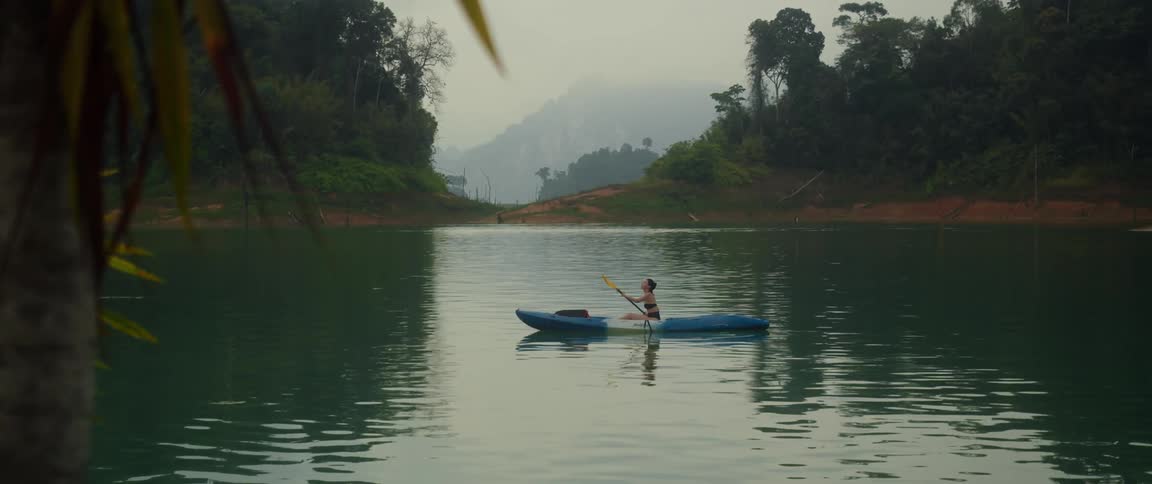 A woman is rowing a canoe in the lake