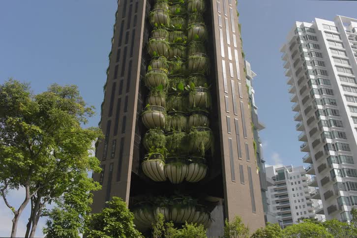 Architecture of a massive building with balconies including green areas