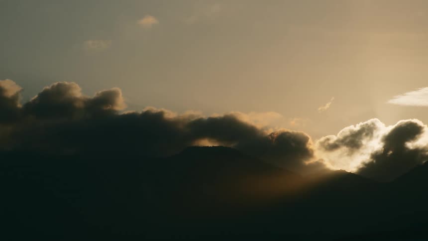 A dense and dark layer of clouds is obscuring the sun behind them