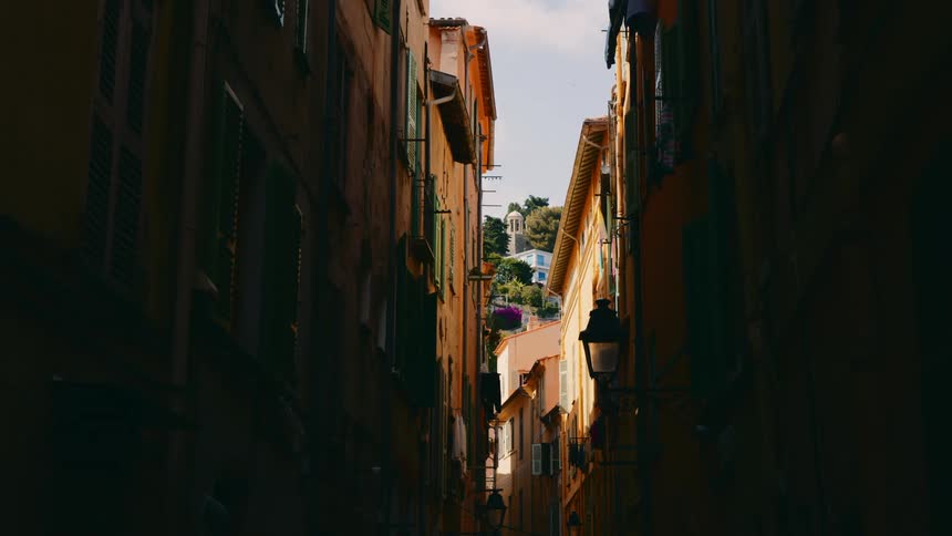 View of a narrow corridor between old and classical residential buildings