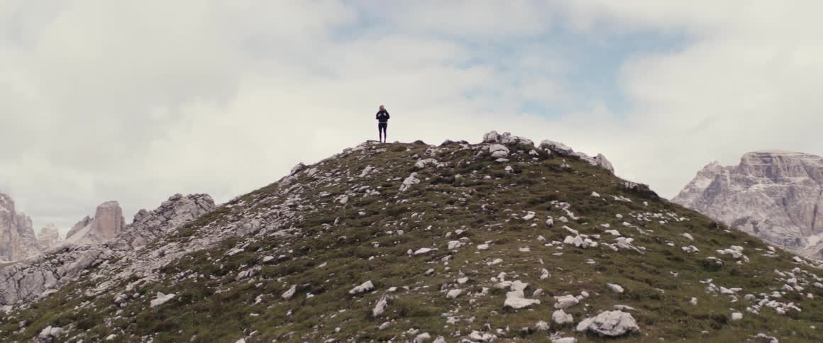 Person on a mountaintop observing the landscape