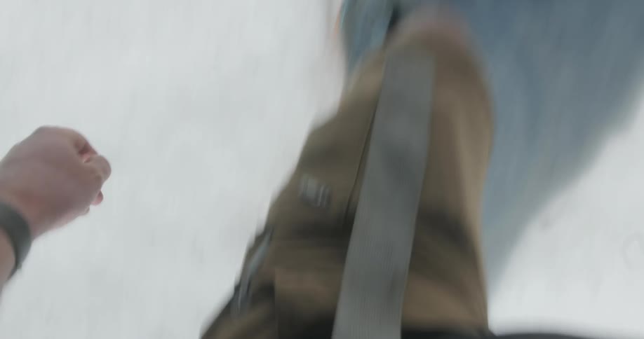 Person hikes in the snow on a sunny day