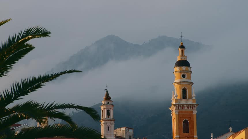 The church towers are by the mountain