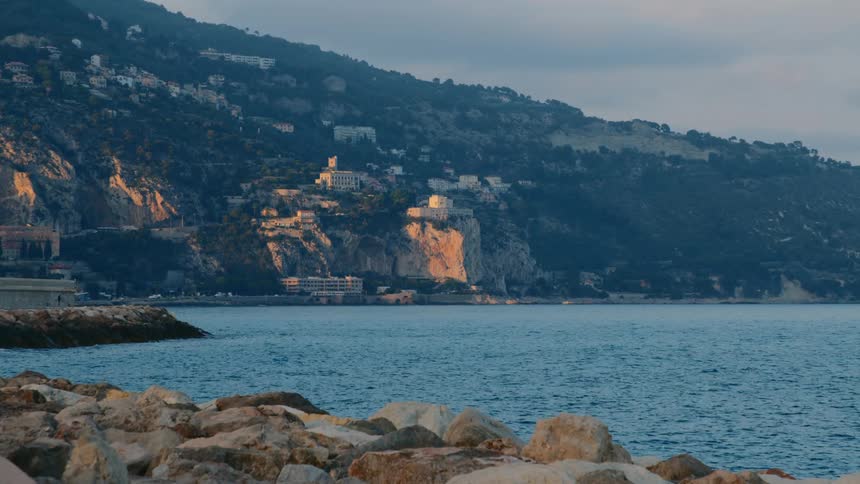 View of a landscape with the sea in motion and on the horizon a coastal area with residential areas