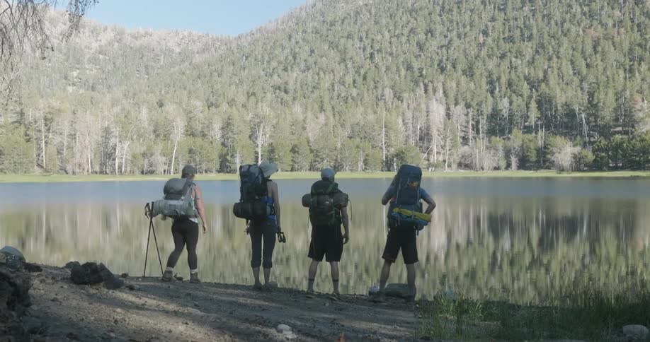 Hikers stop to enjoy a lake view