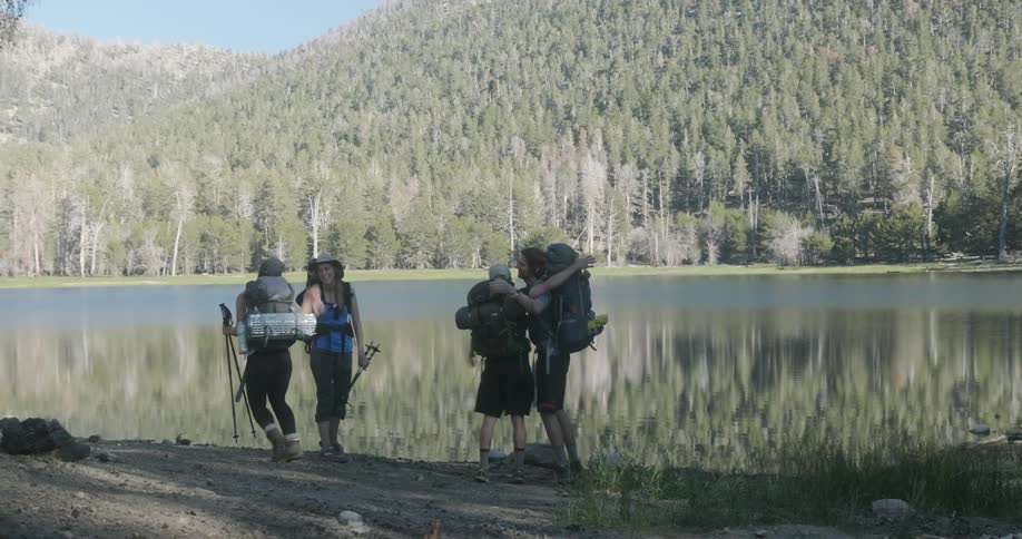 Hikers stop and gather at the lake