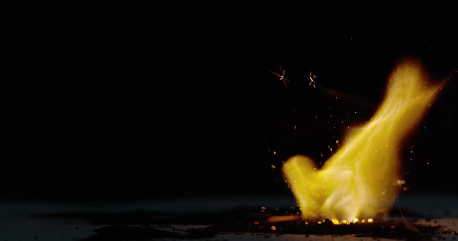 A large fire burns in a pit outside
